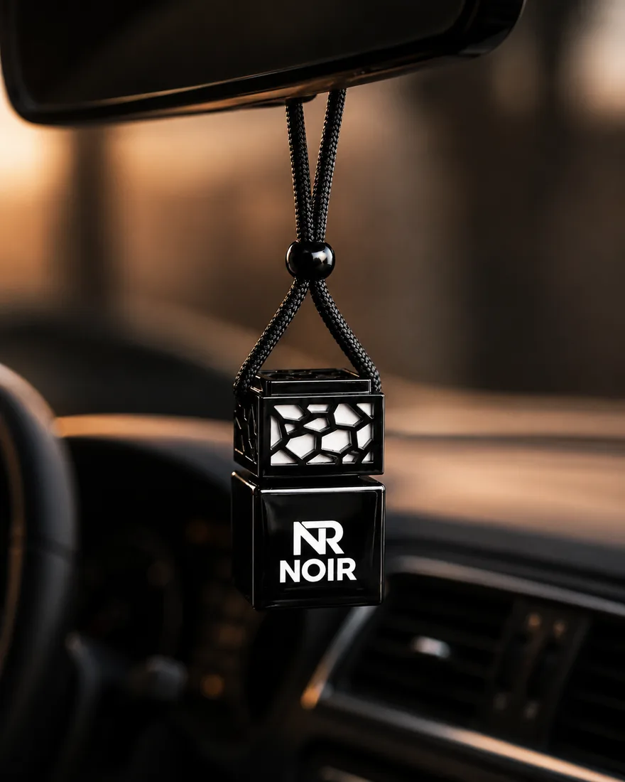 Noir Moris fragrance hanging from a car rear-view mirror